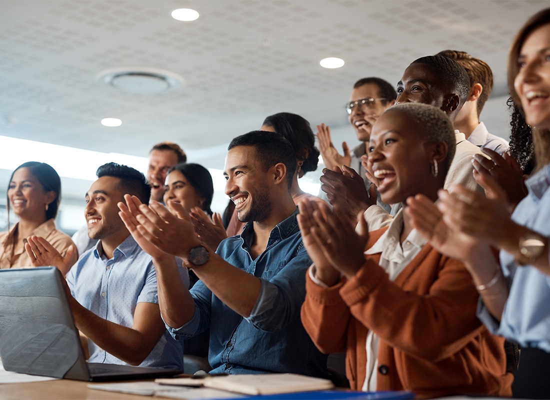Employee Benefits - Group of Diverse Smiling Employees Clapping Their Hands During a Work Conference Meeting